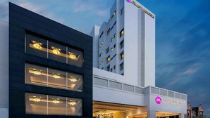 A modern hotel with a prominent 'Grand Mercure' sign, a multi-story structure, and a well-lit entrance. - Grand Mercure Vadodara Surya Palace (Vadodara)
