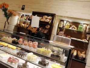 A bakery display case with various baked goods and desserts.