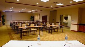 A conference room with a long table, chairs, and water bottles. - Hilton Garden Inn Fayetteville/Fort Bragg (FAYETTEVILLE)