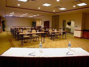 A conference room with a long table, chairs, and water bottles. - Hilton Garden Inn Fayetteville/Fort Bragg (FAYETTEVILLE)