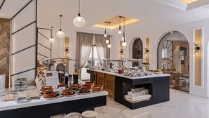 A modern hotel breakfast area with a marble floor, buffet with various food items, pendant lighting, and a view of the outdoors. - Delfina Boutique (Apokoronas)