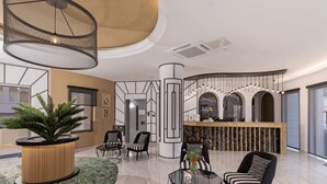 A modern lobby with a reception desk, seating area, and a large plant. - Delfina Boutique (Apokoronas)