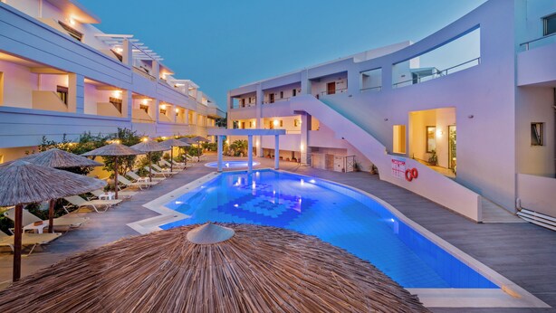 A modern hotel with a swimming pool, sun loungers, and thatched umbrellas. - Delfina Boutique (Apokoronas)