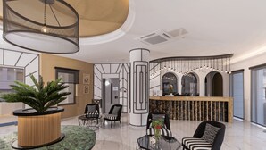 A modern lobby with a reception desk, seating area, and a large plant. - Delfina Boutique (Apokoronas)