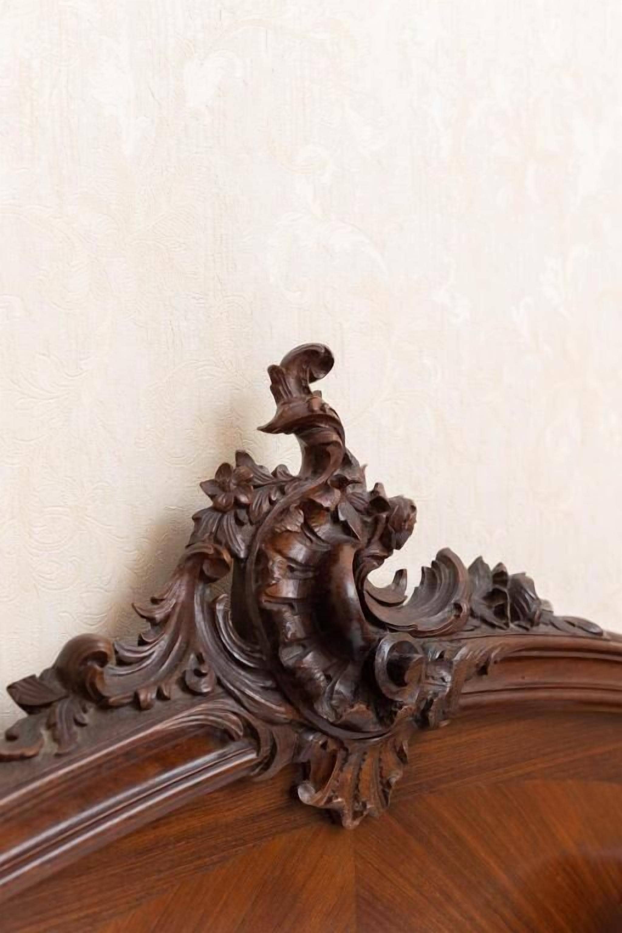 A wooden furniture piece with carved details.