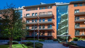 A multi-story building with balconies, a central staircase, and a glass facade. - FriendHouse Apartments - City Center (Kraków)