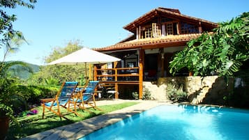 Piscina externa, piscina com cascata, espreguiçadeiras