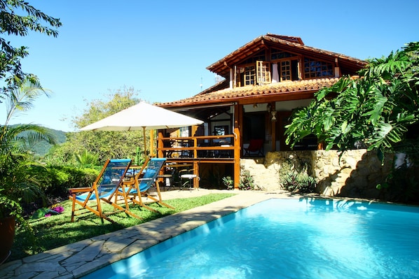 Outdoor pool, a waterfall pool, pool loungers