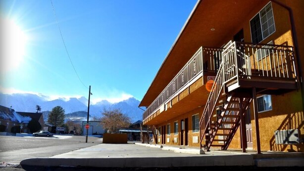 A two-story building with a balcony and a staircase leading to the upper floor. - Mt Whitney Motel (Lone Pine)