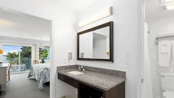 A bathroom with a sink, mirror, and toilet.
