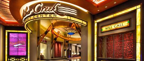 The interior of the Four Winds Hotel with a prominent 'Will Call' sign and a large illuminated sign reading 'Alcar Center'.