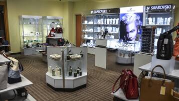A jewelry store with glass display cases and a Swarovski sign.