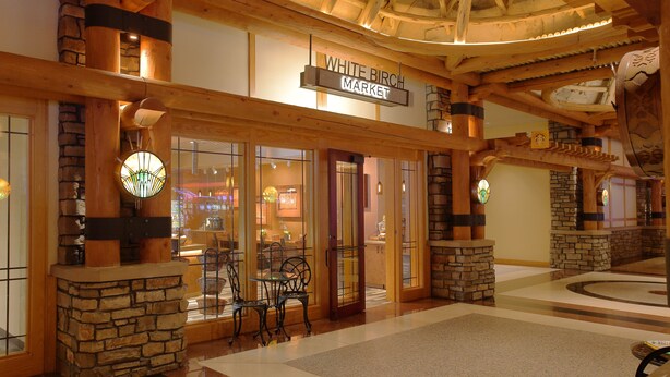 A spacious atrium with a stone and wood interior, a sign reading "White Birch Market," and a seating area with chairs. - Four Winds Casino Resort – New Buffalo (New Buffalo)
