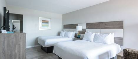 Une chambre d’hôtel avec deux lits, un bureau et une chaise.