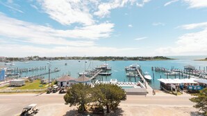 A marina with boats docked, a small building, and a clear sky. - The Anchorage Inn and Marina (Ocracoke)