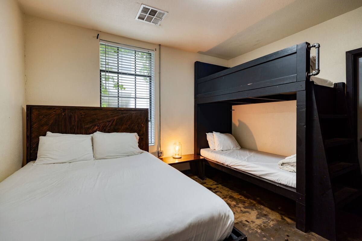 A room with a single bed and a bunk bed.