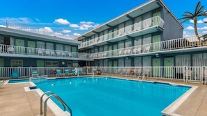 Un hôtel doté d’une piscine, de nombreux balcons et d’espaces de détente en plein air.