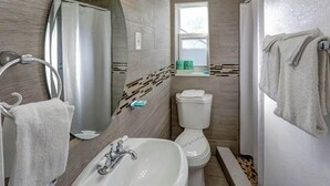A bathroom with a sink, toilet, and shower. - Richard s Motel Extended Stay (Hallandale Beach)
