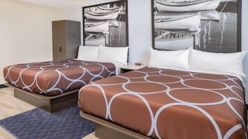 A hotel room with two beds, a wardrobe, and a large window with a view of boats.