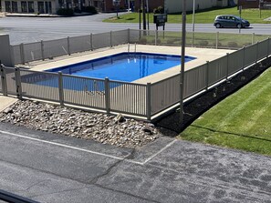 Enjoy a refreshing swim in our outdoor pool surrounded by a secure fence.