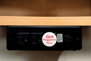A black electronic device with a white label that reads 'Get Plugged-In! RedRoof.' - Red Roof Inn & Suites Swansea (Swansea)