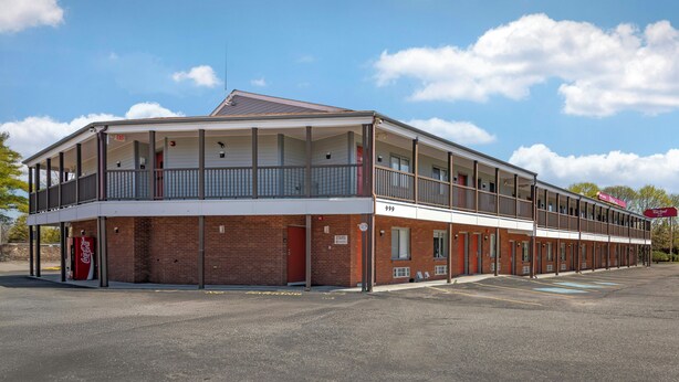 A two-story building with a flat roof, multiple windows, and a covered front porch. - Red Roof Inn & Suites Swansea (Swansea)