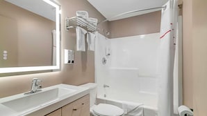 A modern bathroom with a white sink, toilet, and bathtub. - Red Roof Inn & Suites Swansea (Swansea)