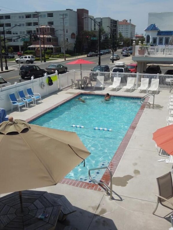 Seasonal outdoor pool, open 9:00 AM to 9:00 PM, pool loungers