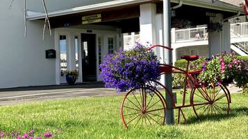 Traditional architecture welcomes you to this charming property with a covered porch and beautifully manicured grounds.