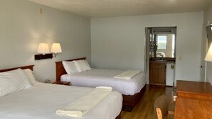 A hotel room with two beds, a desk, and a kitchenette. - Premier Inns Concord (Concord)