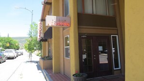 A two-story building with a 'WELCOME' sign above the entrance. - Adobe Inn (Durango)