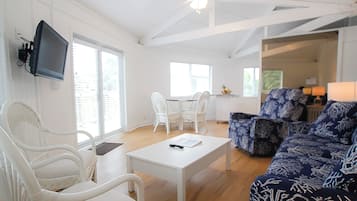 Condo, Multiple Beds | Living area | Flat-screen TV, books