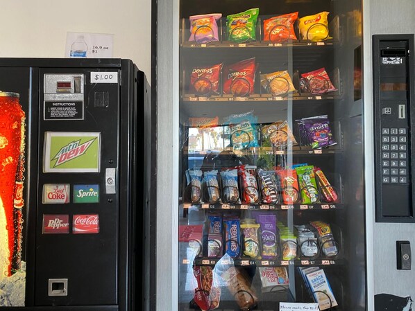 A vending machine with snacks and drinks, including Mountain Dew, Diet Coke, and Sprite.