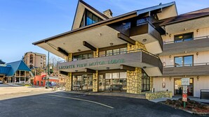 A LEGONTE VIEW MOTOR LODGE with a stone facade, large windows, and a welcoming entrance.