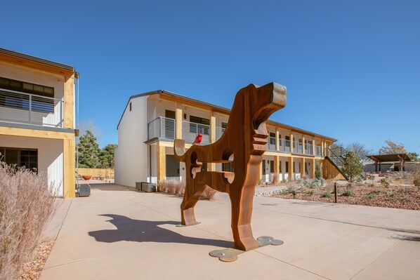 A modern building with a large sculpture in the foreground.