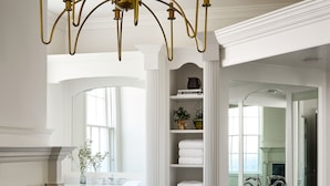 A spacious bathroom with a large mirror, a bathtub, and a vanity with a sink. - Kennebunkport Captains Collection (Kennebunkport)