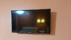 A mirror with a black frame mounted on a wall.