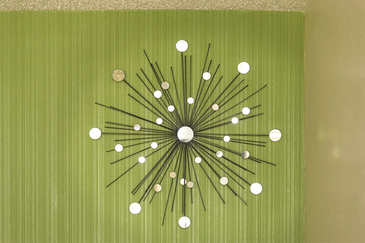 A wall with a geometric, radial design featuring multiple lines and circular elements.