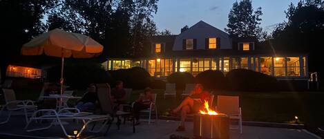 A patio area with outdoor seating and a fire feature.