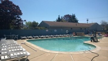 Seasonal outdoor pool, open 9:00 AM to 10:00 PM, pool umbrellas