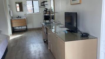 Desk, laptop workspace, blackout drapes, iron/ironing board