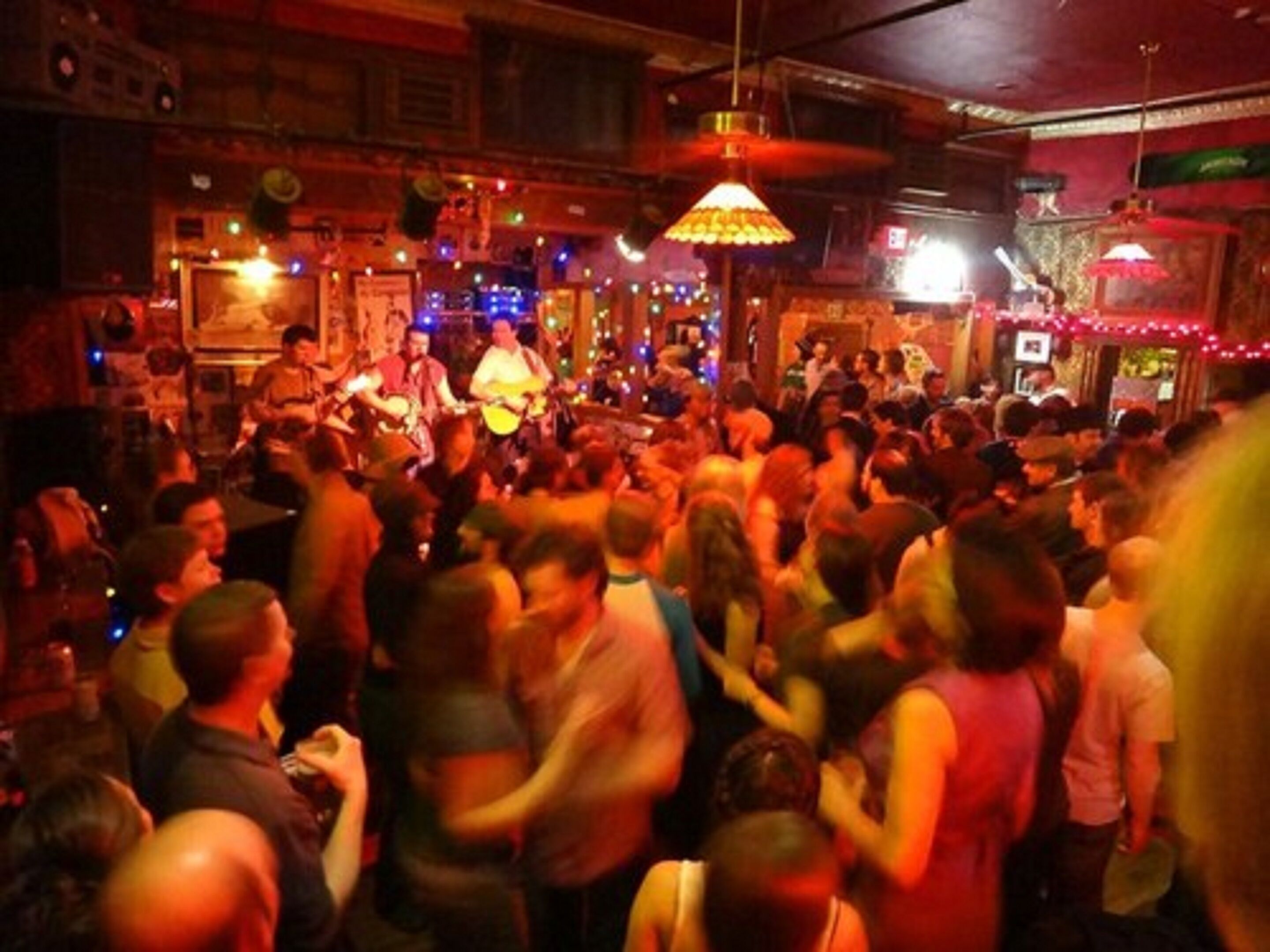A crowded bar with a band performing.