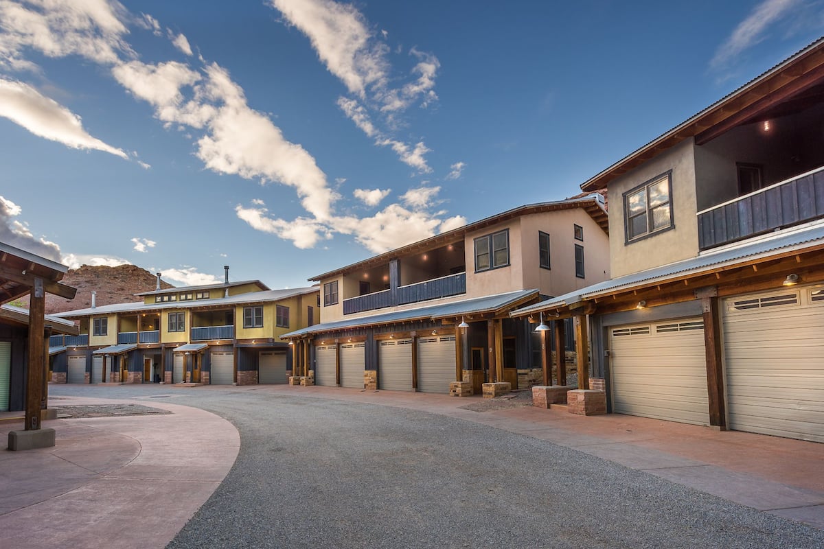 A residential area with multiple houses, each featuring a garage and a balcony.