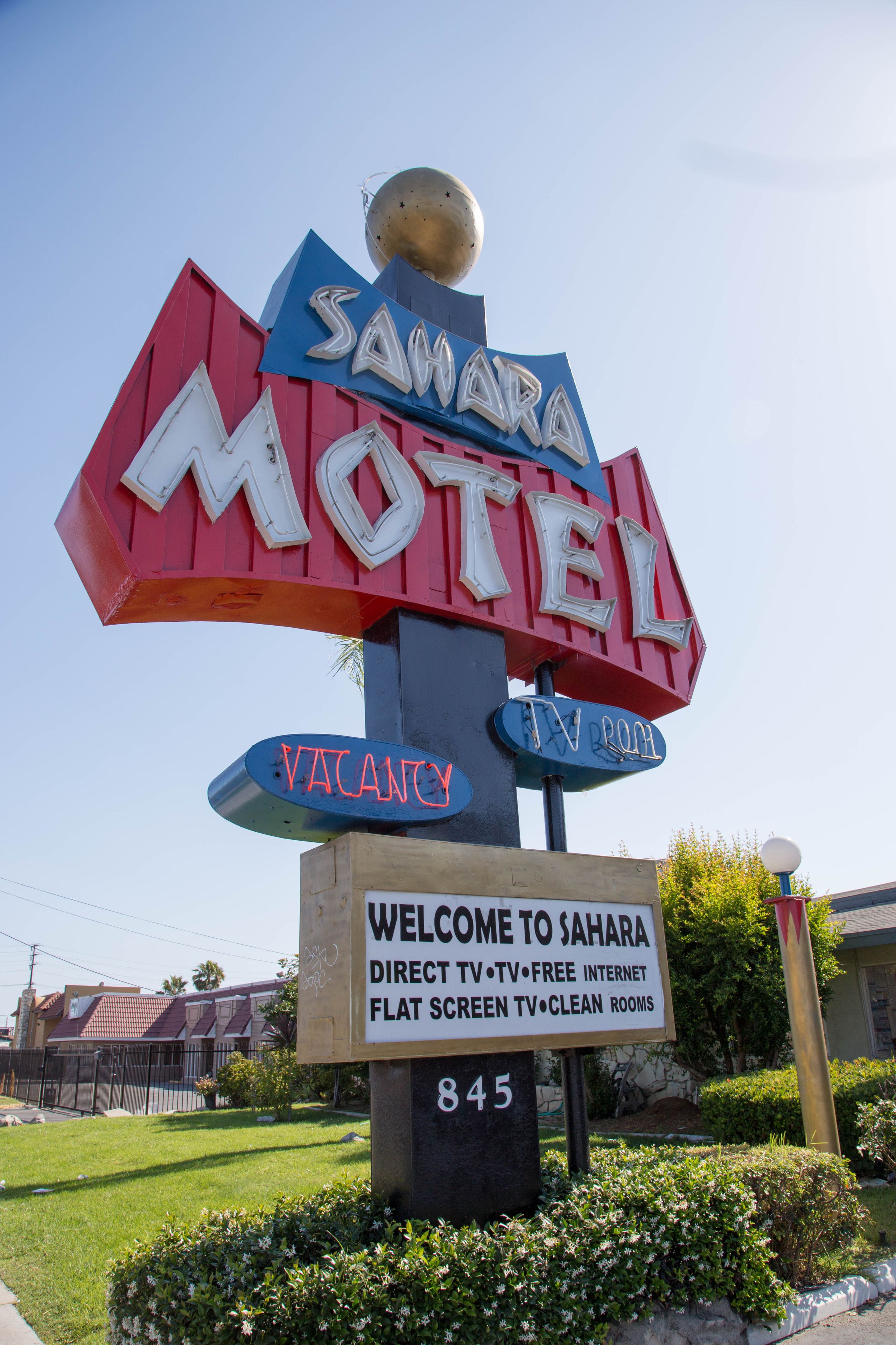 Ein Schild eines Motels mit der Aufschrift 'Sahara Motel' und 'Freie Zimmer'.