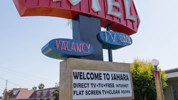 A motel sign with "Sahara Motel" and "Vacancy" displayed.