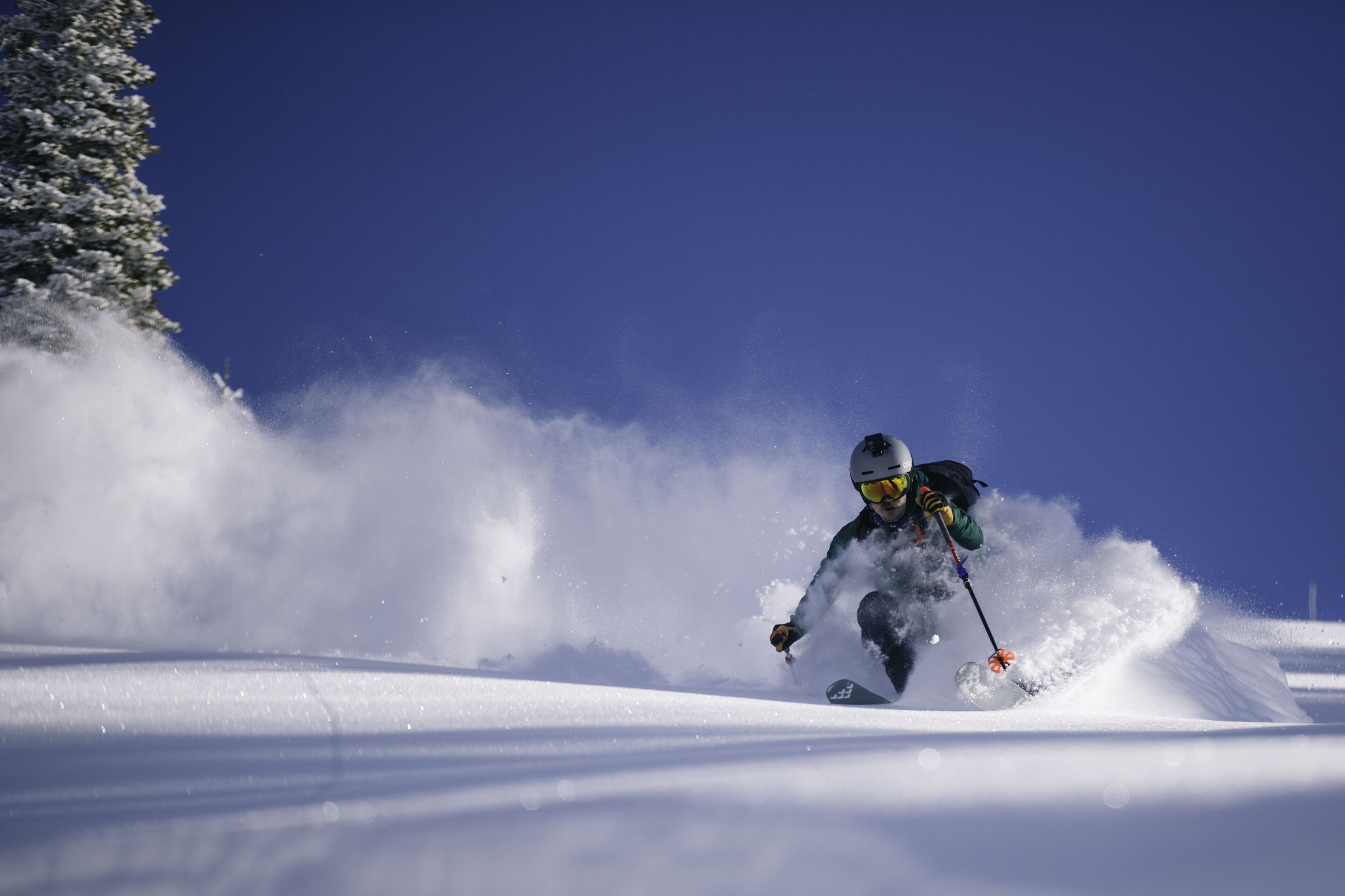 A skier in motion on a snowy slope.