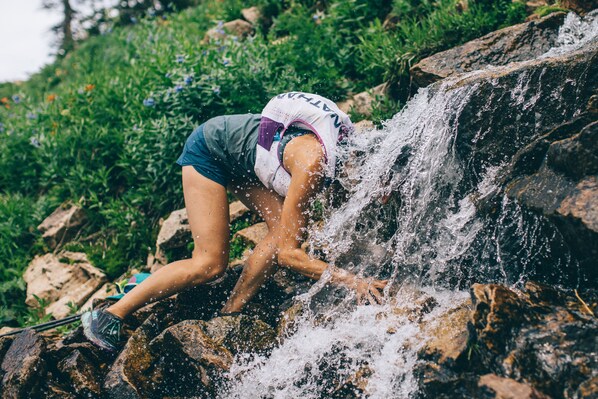 A person climbing a rocky waterfall. - The Stranger Lodge (Sisters)