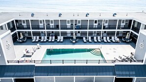 A multi-level outdoor deck with lounge chairs and a pool.
