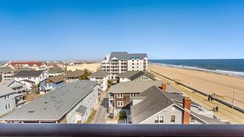 A coastal residential area with a prominent hotel overlooking the beach.