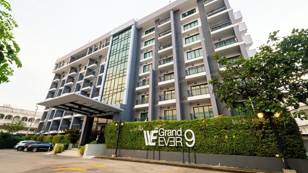 A multi-story hotel with a modern facade, balconies, and a sign reading "Grand Ever 9". - WE GRAND EVER 9 (Nakhon Ratchasima)